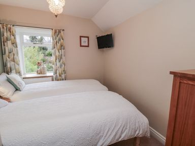 A bedroom with two beds and a window at 21 High Street, Scarborough