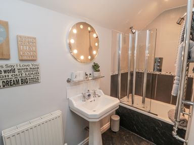 A bathroom with a sink and shower at 21 High Street in Scarborough