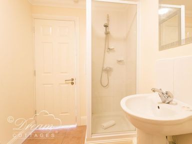 A bathroom with shower and sink at Harbourside Apartment in Weymouth