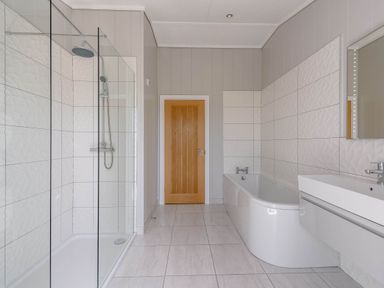 A bathroom with a shower and bathtub at Wellington in Wigton