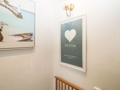 A hallway with artwork and framed print at 58A South Ford Road in Dartmouth
