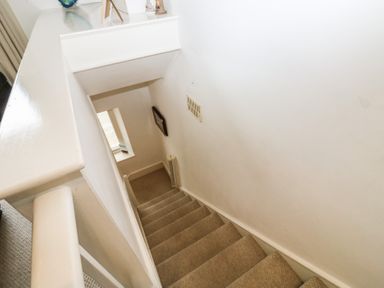 A staircase leading down with a window at 58A South Ford Road Dartmouth