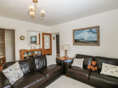 A living room with a sofa and bookshelf at 58A South Ford Road in Dartmouth