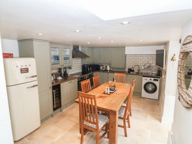 A kitchen with a table and chairs at 58A South Ford Road Dartmouth