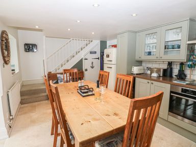 A kitchen with a dining table and chairs at 58A South Ford Road Dartmouth