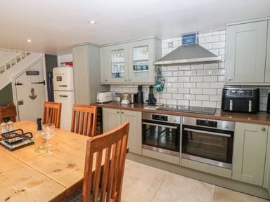 A kitchen with dining table and refrigerator at 58A South Ford Road in Dartmouth