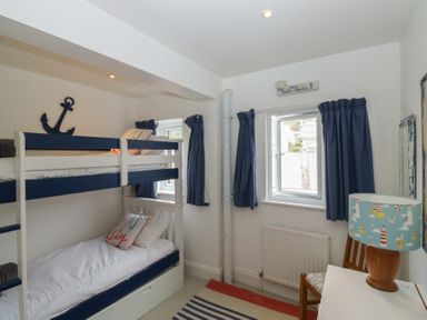 A bedroom with bunk beds and a lamp at 58A South Ford Road Dartmouth