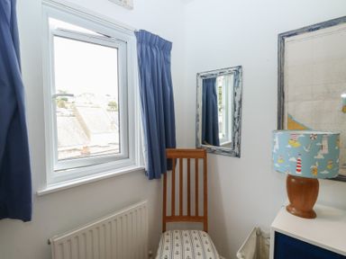 A corner of a room with a chair and lamp at 58A South Ford Road Dartmouth