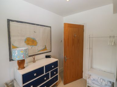 A bedroom with a map and a lamp at 58A South Ford Road, Dartmouth