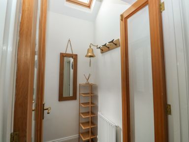 A hallway with a mirror and shelving unit at 58A South Ford Road Dartmouth