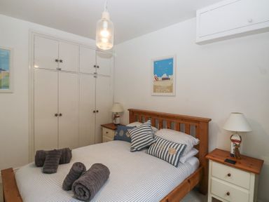 A bedroom with a bed and wardrobe at 58A South Ford Road in Dartmouth