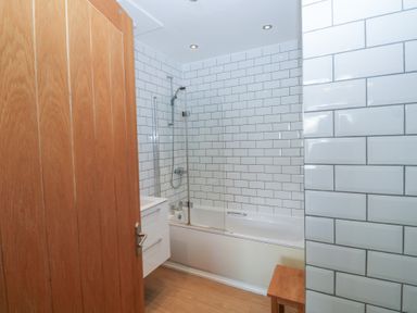 A bathroom with a bathtub and shower at 58A South Ford Road Dartmouth