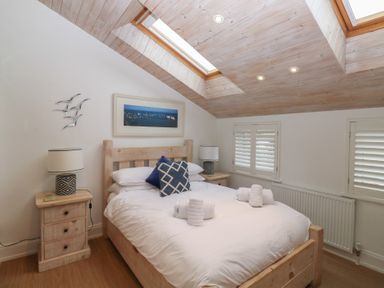 A bedroom with a bed and bedside lamps at 58A South Ford Road in Dartmouth
