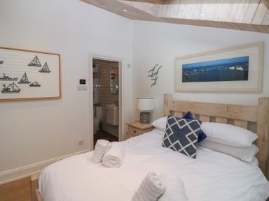 A bedroom with a bed and artwork at 58A South Ford Road in Dartmouth