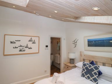 A bedroom with a bed and artworks at 58A South Ford Road Dartmouth