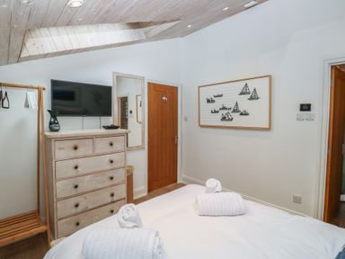 A bedroom with a bed and television at 58A South Ford Road in Dartmouth