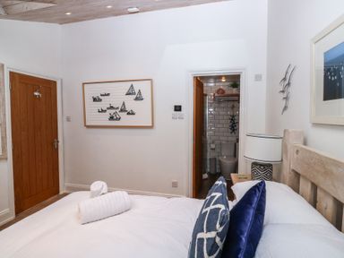 A bedroom with a bed and an ensuite bathroom at 58A South Ford Road in Dartmouth