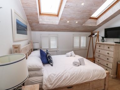 A bedroom with a bed and dresser at 58A South Ford Road in Dartmouth