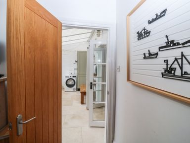 A laundry room with a washer and wooden table at 58A South Ford Road Dartmouth