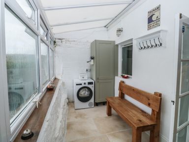 A utility room with a washing machine and a storage cabinet at 58A South Ford Road, Dartmouth