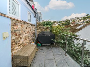 A patio with a barbecue grill and outdoor furniture at 58A South Ford Road Dartmouth