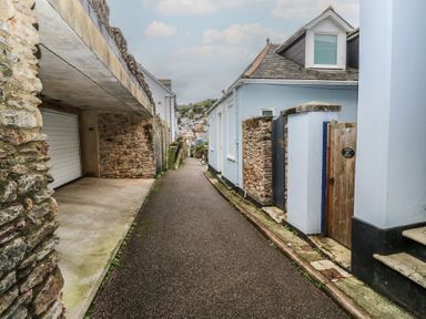 A narrow pathway between buildings at 58A South Ford Road Dartmouth