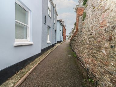 A narrow path between buildings at 58A South Ford Road in Dartmouth