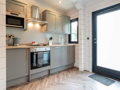 A kitchen with cabinets and appliances at Askrigg (Pet) Aysgarth