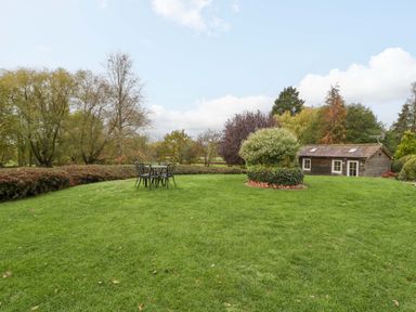 A garden with a table and chairs at The Log Cabin in Corse near Gloucester