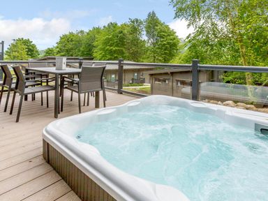 An outdoor area with a hot tub and dining table at Wensleydale Aysgarth