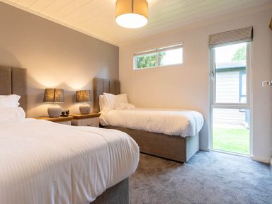 A bedroom with two beds and a window at Wensleydale in Aysgarth
