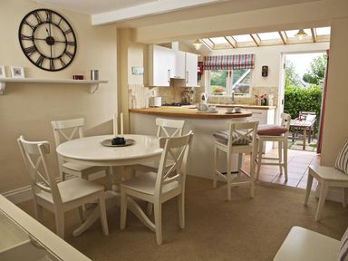 A dining room with a table and chairs at St Leonards in Salcombe