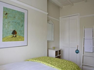 A bedroom with a bed and painting at St Leonards in Salcombe