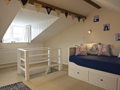 A bedroom with a bed and decorative pillows at St Leonards in Salcombe