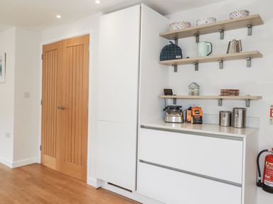A kitchen with cabinets and appliances at Hillbre Trevone