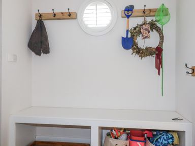 An entryway with hooks and a bench at Hillbre in Trevone