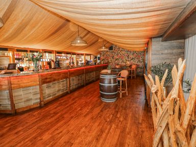 A bar area with stools and tables at Glamping Pod 1, Oldwalls, Llanrhidian, Gower