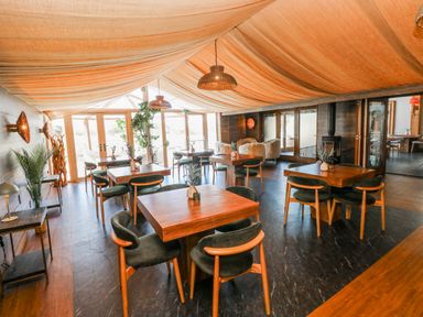 A dining room with tables and chairs at Glamping Pod 1 Oldwalls, Llanrhidian, Gower