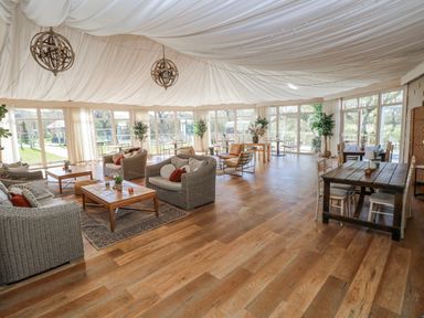 A seating area with sofas and tables at Glamping Pod 1, Oldwalls, Llanrhidian, Gower