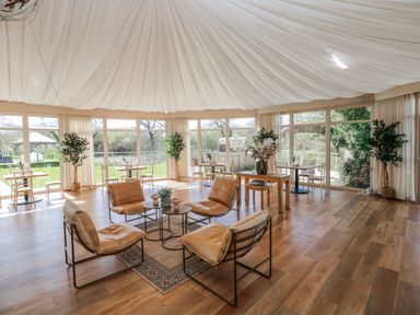 A seating area with a table and plants in Glamping Pod 1, Oldwalls, Llanrhidian, Gower