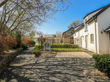 An outdoor area with a garden sign and pathways at Glamping Pod 1 in Oldwalls, Llanrhidian, Gower