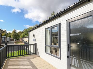 A deck with a door and window at Altair Lodge in 