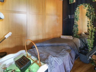 A spa room featuring a massage table and foot spa at Garden lodge 3 Swansea
