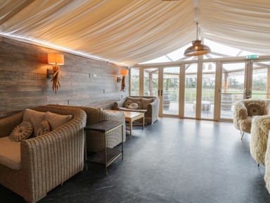 A snug with seating and a coffee table at Garden lodge 3 in Swansea