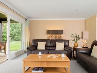 A living room with a sofa and coffee table at The Allensford in Slaley