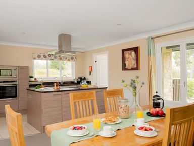 A kitchen with a dining table set for breakfast at The Allensford in Slaley