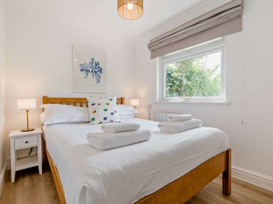 A bedroom with a bed and nightstand at Kernow Nook Spa in Perranporth