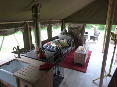 A tent with a sofa and stove in Ceri Newcastle Emlyn