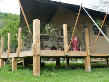 A deck with outdoor furniture and a tent at Ceri in Newcastle Emlyn