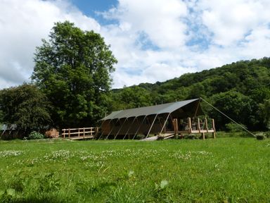 A tent structure with a wooden deck and grass area at Ceri in Newcastle Emlyn